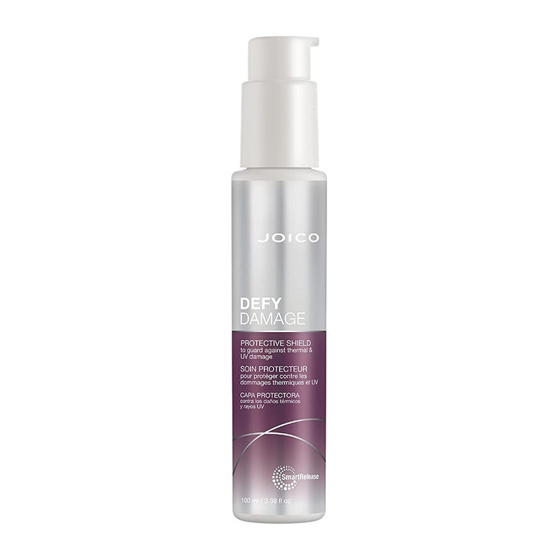 A silver and purple bottle of the Joico Defy Damage Protective Shield on a white background