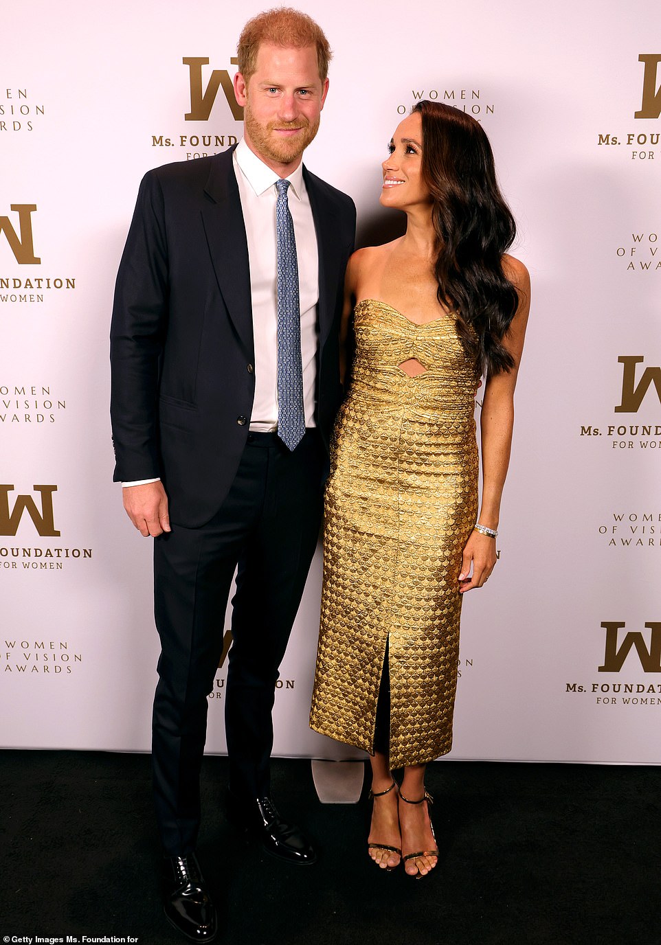 The Duchess of Sussex was joined at the event by her husband Prince Harry - and the couple posed for a few photos on the red carpet, although they opted to wait until the carpet's livestream had ended before stepping in front of the cameras