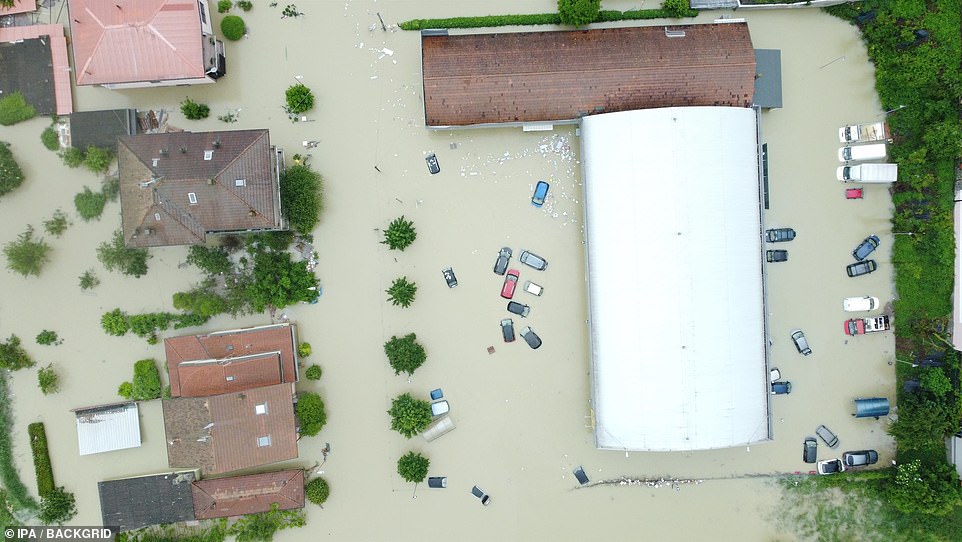 At least four people have died and thousands have been evacuated from their homes across northern Italy today as devastating floods triggered by torrential rain tore through dozens of towns. Pictured: Cars and homes were submerged in water in Cesena after the Savio river burst its banks on Wednesday