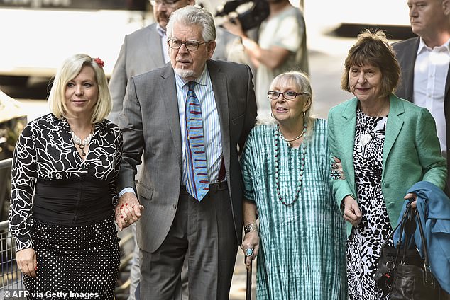 Rolf Harris arrives with his wife Alwen Hughes (second right) and daughter Bindi (left) at Southwark Crown Court in central London on June 30, 2014