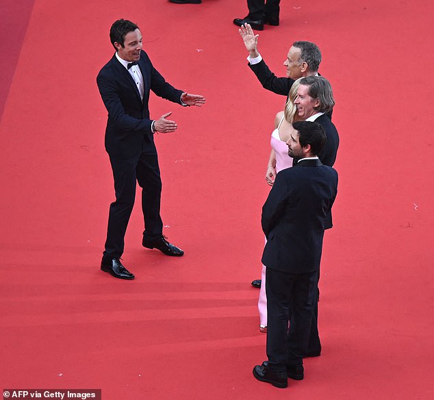 Irgendwann schien der Mann Tom zu gestikulieren, als er mit seinen Co-Stars auf dem Teppich für Fotos posierte