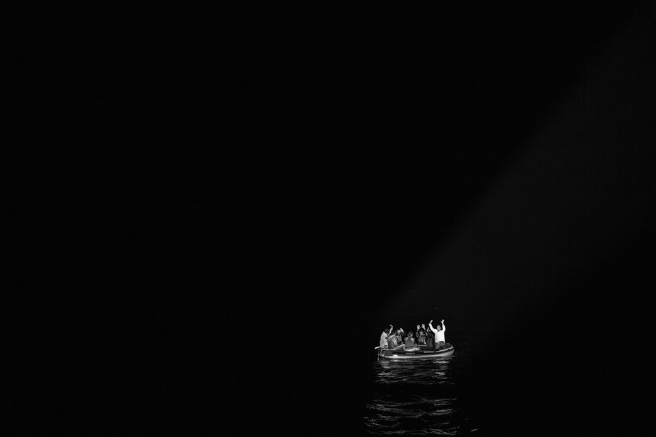 Bild eines Bootes voller Migranten, beleuchtet von den Taschenlampen der türkischen Küstenwache in Bodrum, Türkei