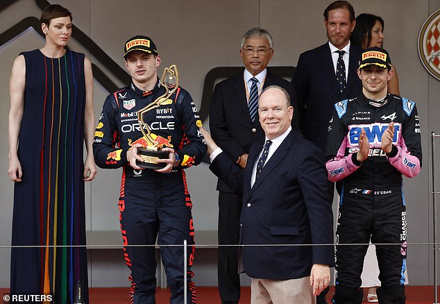 Red Bull's Max Verstappen is presented with the winner trophy on the podium by Prince Albert II of Monaco after winning the Monaco Grand Prix as Princess Charlene looks on
