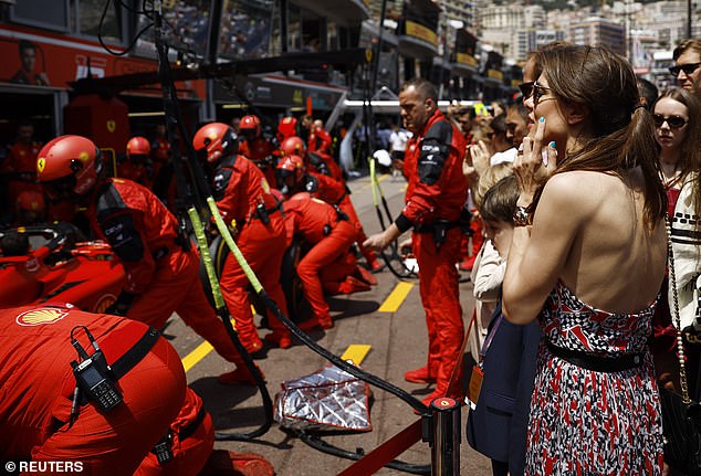 Charlotte was snapped intently watching the Ferrari pit crew do a pit stop right in front of her as she donned a dress in their signature colour - red