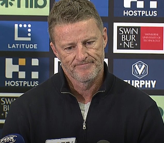 An emotional Damien Hardwick is pictured announcing that he is officially standing down as coach of the Richmond Tigers in the AFL