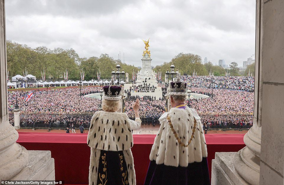 An official photo released by Buckingham Palace following the Coronation today shows King Charles and Queen Camilla waving to tens of thousands of cheering Royal fans who waited patiently on The Mall to see them