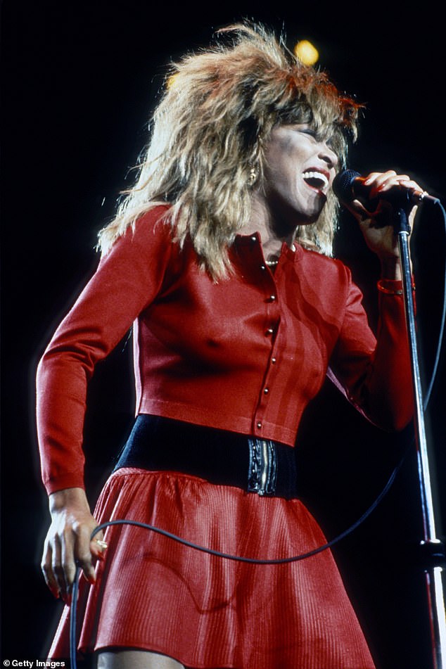Tina Turner pictured performing in New York City in 1987 wearing her most iconic blonde and backcombed wig
