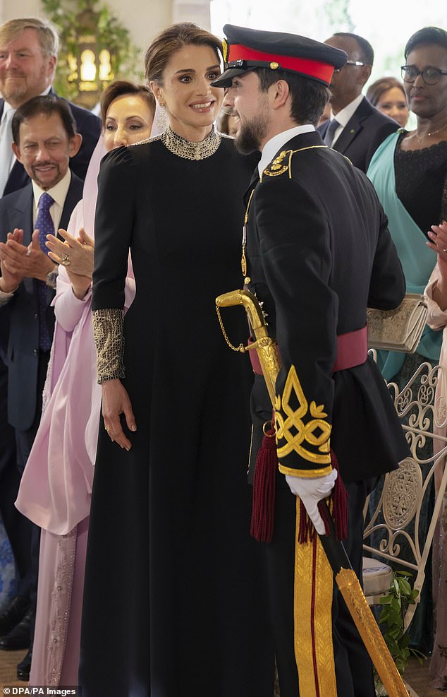 Queen Rania of Jordan speaks with her son during yesterday's celebrations in Amman