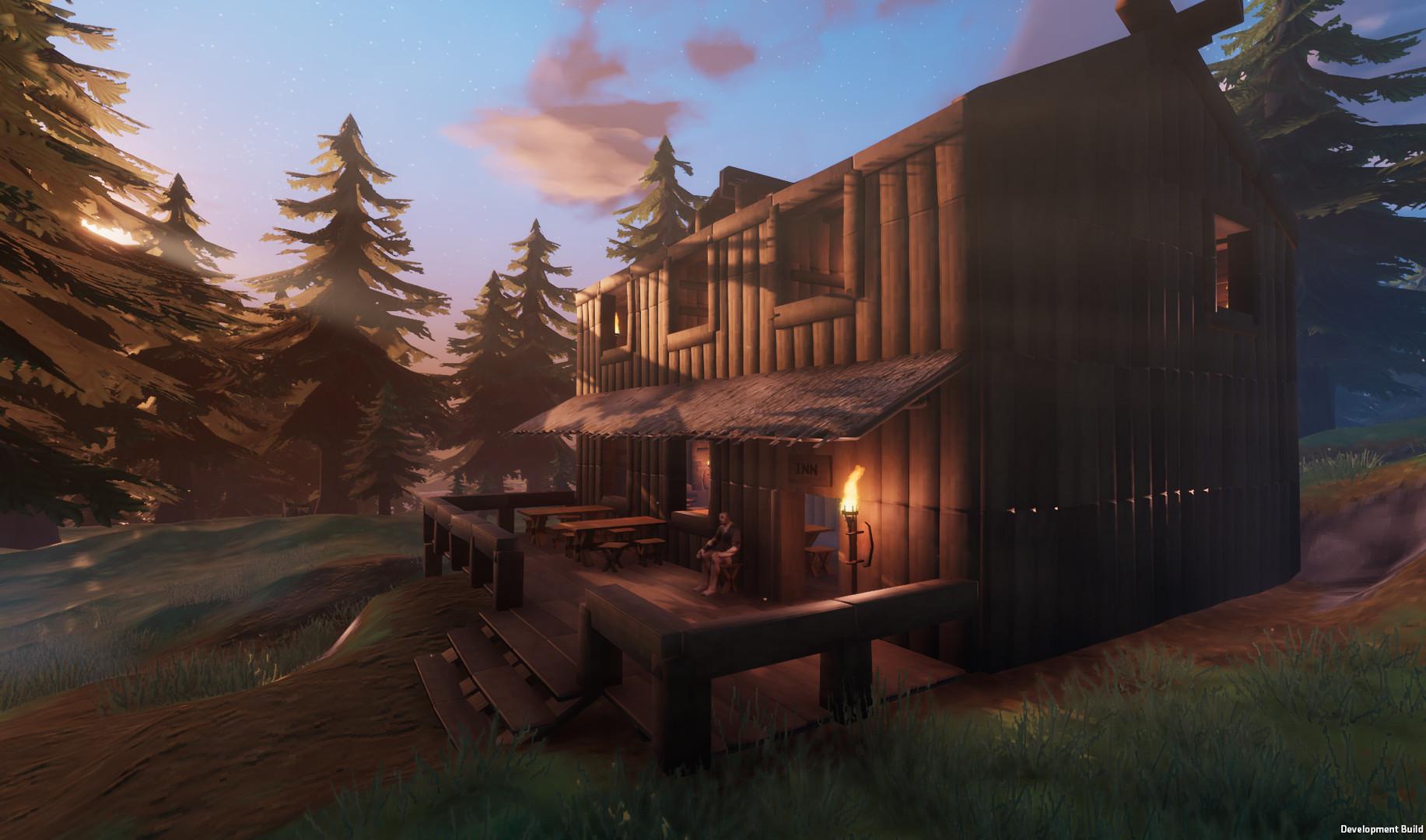 „Valheim“-Spieler sitzt vor einem Holzgebäude, das sie gebaut haben.