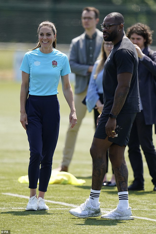 Kate beamed in the sunshine as she received her instructions ahead of carrying out drills on the pitch