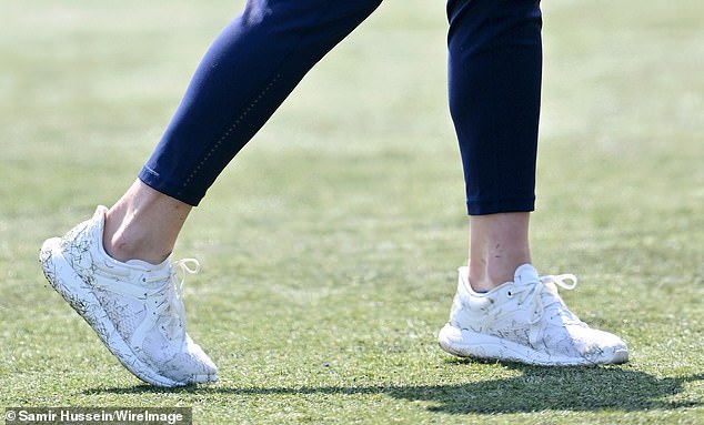 It wasn't long before Kate's brilliant white Lululemon trainers were covered in grass from the pitch
