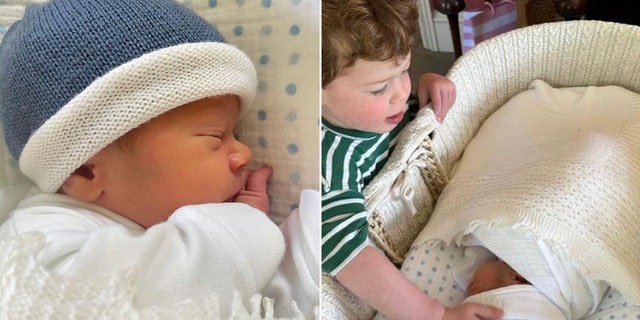 Ernest in einem Kinderbett mit blauer Mütze teilte August in einem grün gestreiften Hemd und begrüßte Baby Ernest in seiner Wiege
