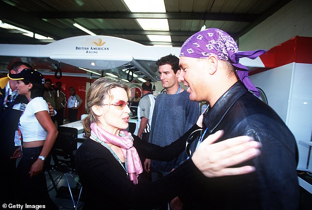 Warne and Kylie Minogue catch up at the 2001 British Grand Prix at Silverstone