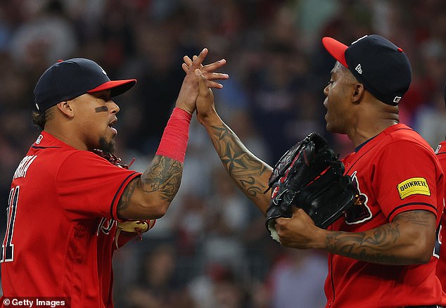 Orlando Arcia and Raisel Iglesias celebrate the Braves' 3-2 win over the Nationals on Friday