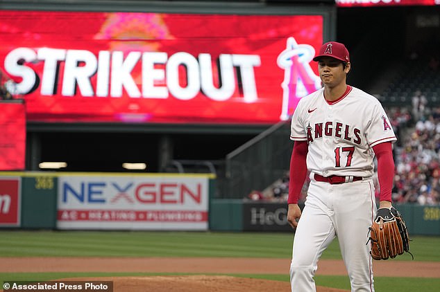Angels starting pitcher Shohei Ohtani walks off the field after striking out Eugenio Suarez