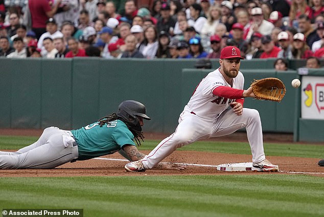 Mariners' J.P. Crawford dives back to first as Angels first baseman Jared Walsh takes the throw