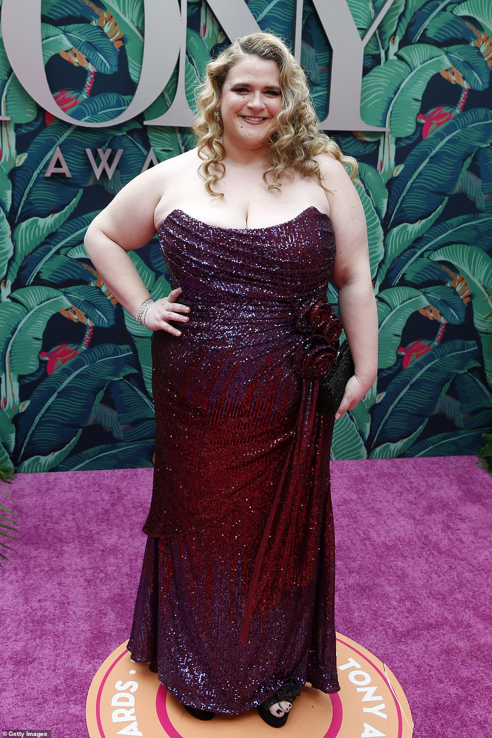Glittering: Bonnie Milligan donned a shimmering burgundy hued number; the strapless dress had ruched detailing