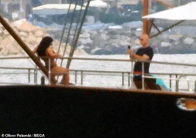Bezos played the doting Instagram boyfriend as he snapped pictures of Sanchez as she posed on the deck