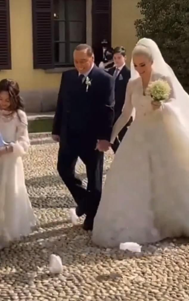 Former Italian prime minister Berlusconi beamed with joy as he celebrated a 'symbolic wedding' with his 32-year-old MP girlfriend last year
