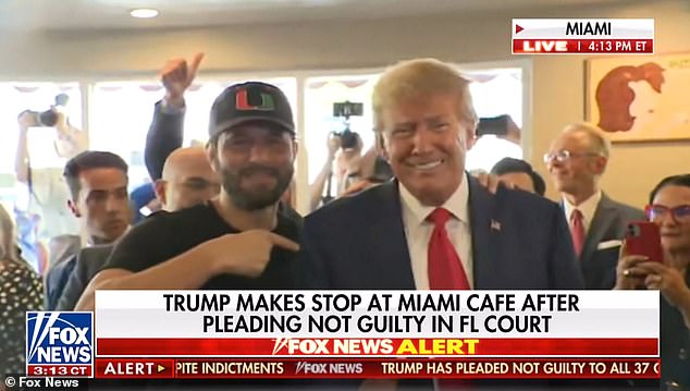 The former president (right) posed for a photo with mixed martial arts fighter Jorge Masvidal (left) at the Miami Cuban restaurant Versailles Tuesday