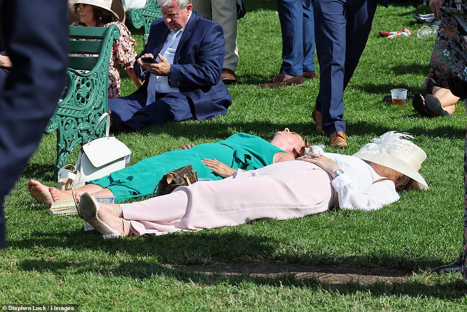 Catching forty winks! This pair of racegoers had a little snooze during the afternoon and sunbathed while the festivities continued