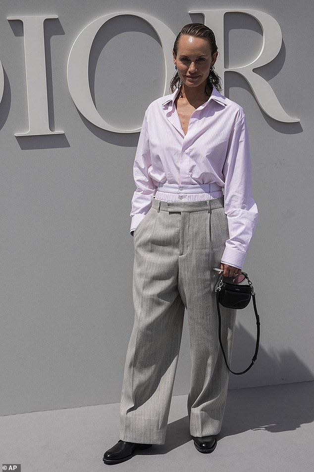 Chic! Amber Valletta oozed androgynous chic i a pink blouse and grey trousers