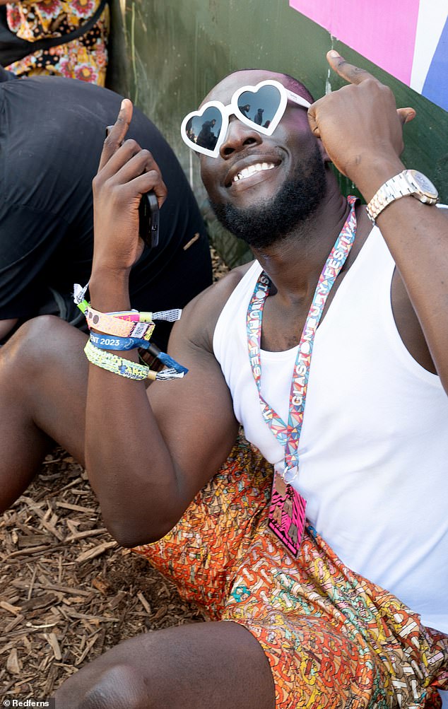 All smiles: Stormzy appeared in excellent spirits as he posed for snaps while relaxing in between sets at the festival