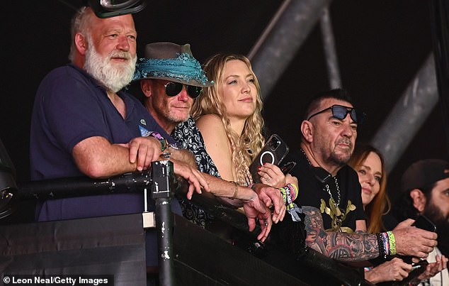 Fame game: The singer was watched on on by the likes of fashion designer Stella McCartney, 51 (right), and actress Kate Hudson, 44 (third left), at the site in England's Somerset