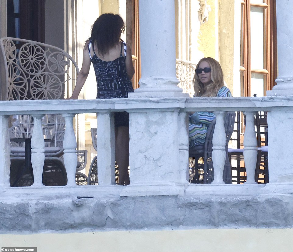 Relaxing: Beyonce was seen sitting down and relaxing on the luxury rooftop as she chatted with a pal