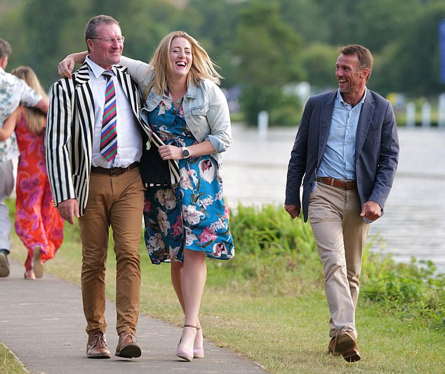 One reveller could count on the support of her friends as she left Henley holding on to a gentleman's jacket