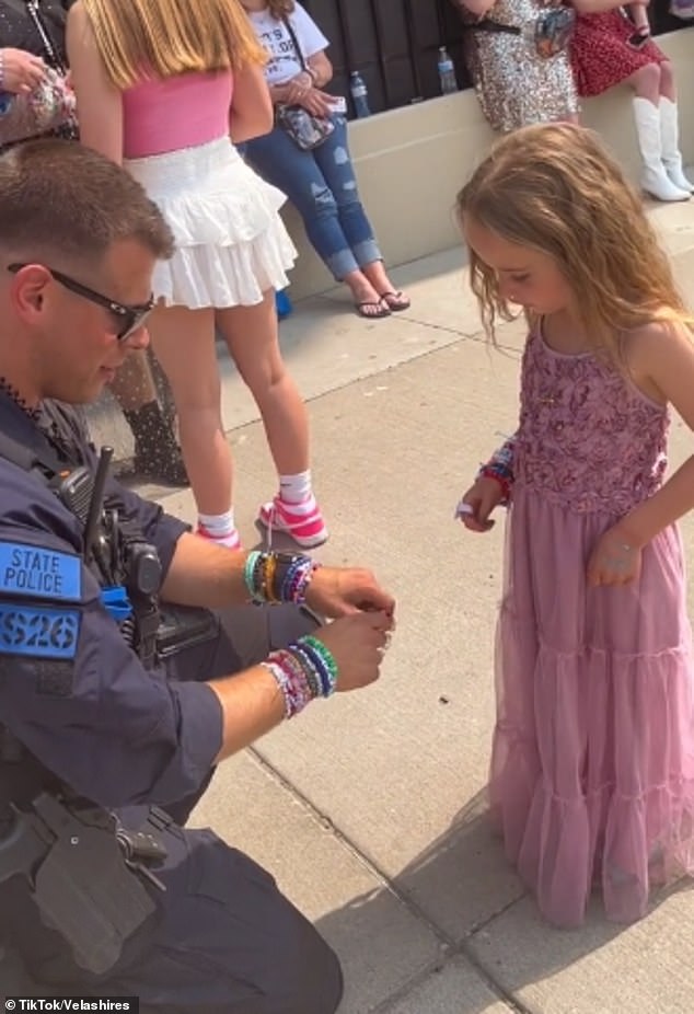 Bei dem unbestreitbar niedlichen Austausch beim Taylor-Swift-Konzert in Detroit, Michigan, lässt der Polizist Justin Roberts die siebenjährige Scarlett Wood das Armband auswählen, das sie haben möchte