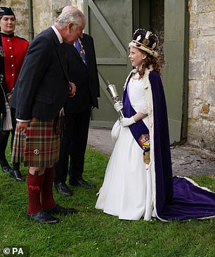 King Charles III greets the Bo'ness Fair Queen, Lexi Scotland, during his visit to Kinneil House, marking the first Holyrood Week since his coronation