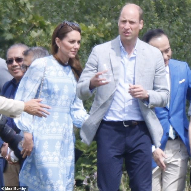 Kate, who opted for a £550 baby blue midi dress from designer Beulah London for the occasion, had earlier offered one of her famous supportive pats to her husband