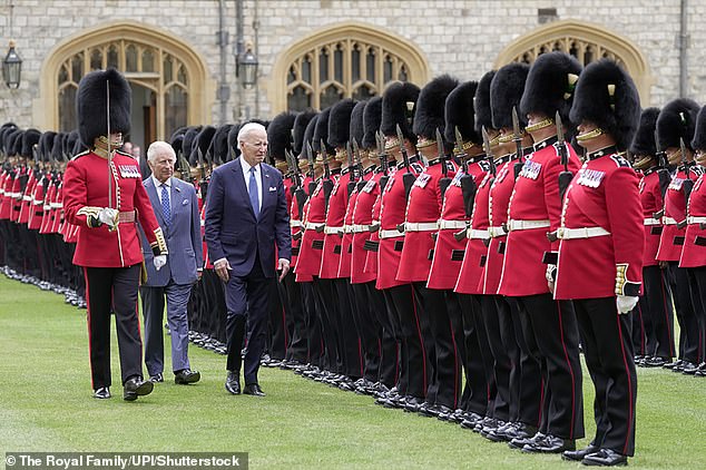 King Charles follows Biden as they inspect the Welsh Guards during the Windsor Castle welcome ceremony
