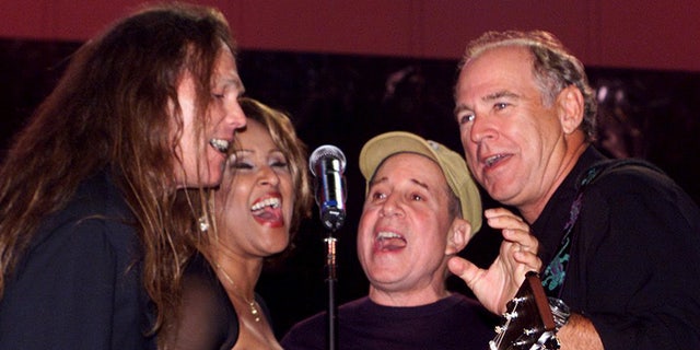 Timothy B. Schmit performing on stage with Jimmy Buffett