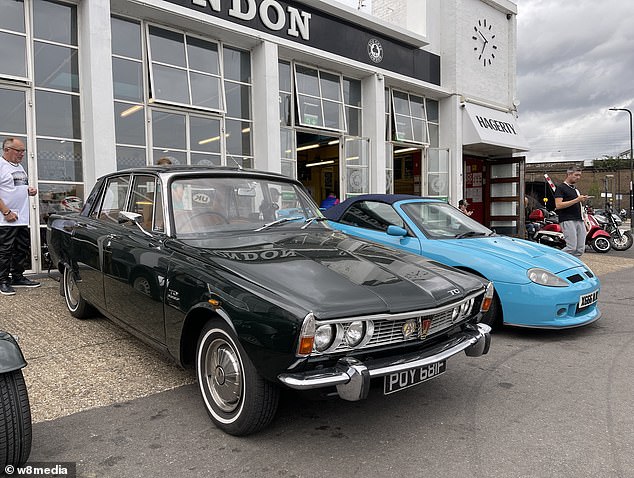 A classic car fan looks at the rear of this wonderful Rover P6 TC, where hidden from view was its state-of-the-art De Dion rear axle with in-board disc brakes. For petrol heads, this is special