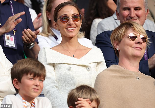 Djokovic's wife Jelena smiled on as she watched the trophy ceremony after the match