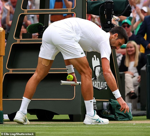A sheepish Djokovic bent down to pick up the pieces of his broken racket after hitting the net