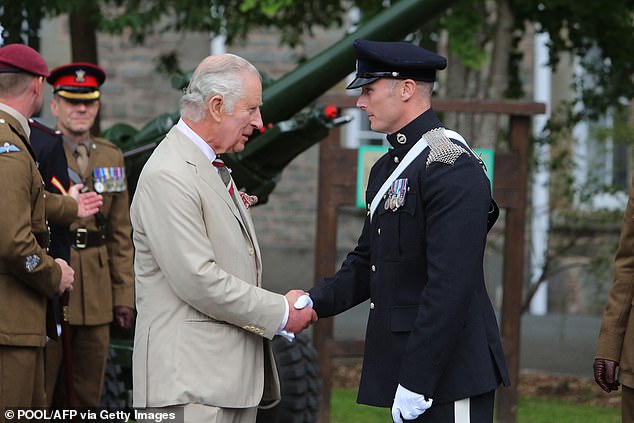 King Charles meets Sgt Adam Humphreys of 1st The Queen's Dragoon Guards (The Welsh Cavalry) during a visit to Brecon Barracks