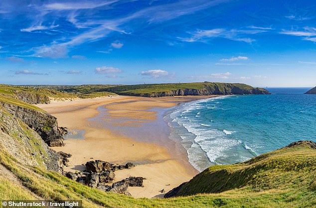 HOLYWELL BAY, NEAR NEWQUAY, CORNWALL: The National Trust says that this spot is 'a classic north Cornish beach with a sweep of golden sand and a towering dune system', while Tripadvisor reviewers describe it as 'beautiful' and 'unspoilt' with 'clear waters'