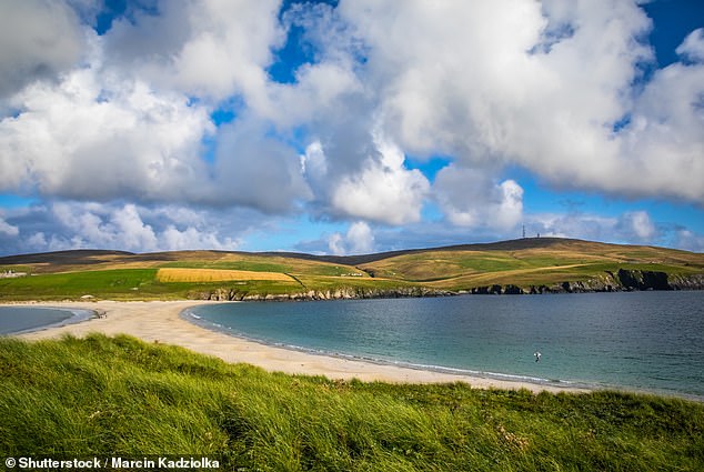 ST NINIAN'S BEACH, THE SHETLAND ISLANDS: Watch as St Ninian's Isle and its sandy tombolo get 'bathed in a warm golden light' during the sunset, says Visit Scotland