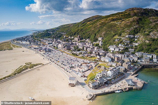 BARMOUTH BEACH, GWYNEDD: This Blue Flag beach boasts a one-mile promenade and is never overcrowded, according to Tripadvisor, which says it has 'that vintage seaside atmosphere of candy floss and donkey rides'
