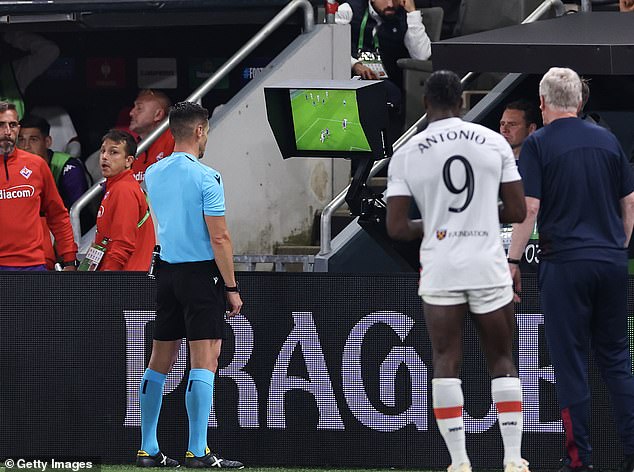 A VAR team can advise to the referee to overturn or change a decision. The ref also has the option to watch a replay on a pitch-side monitor (pictured here during the Europa League final in June)