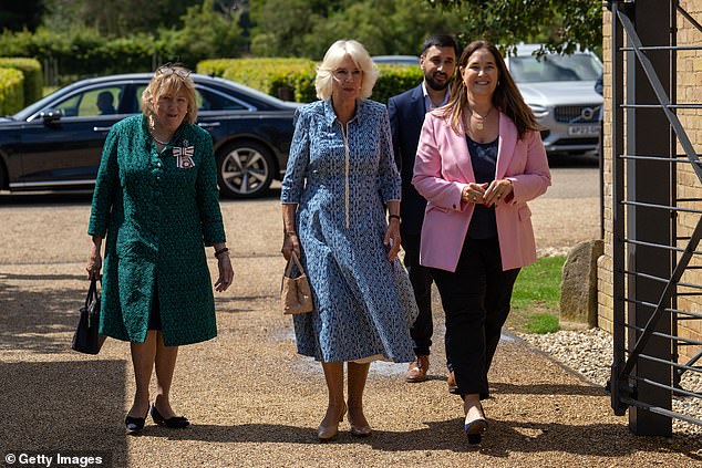 Pictured: Queen Camilla walking with Monica Vinader and Lady Dannatt, Lord Lieutenant of Norfolk