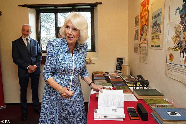 Queen Camilla prepared to sign a copy of the Black Beauty book, written by Anna Sewell, as she visited the sanctuary