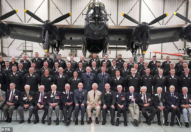 The King posed for a photograph with staff and World War Two veterans during today's visit and afternoon tea