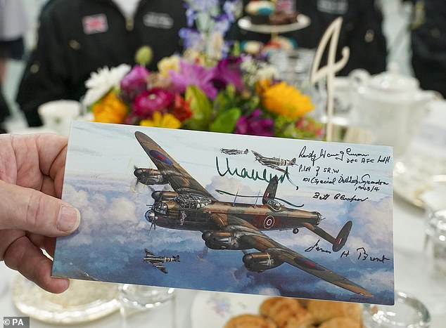 King Charles autographed Rust Waugham's picture as he today spoke with veterans at the afternoon tea