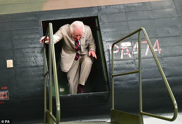 King Charles pictured stepping out of one of the planes on display in the historic RAF base in Lincoln