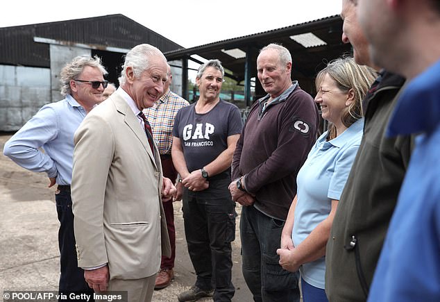 King Charles pictured speaking with members of staff at Lincolnshire Poacher Cheese farm in Ulceby