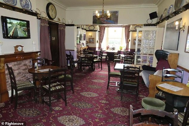 The traditional pub has oak beams and the dining room has a vintage patterned carpet